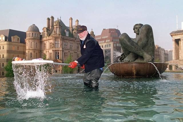 PICTURE FROM THE ARCHIVE: Tony Room goes on his daily early-morning "fishing" expedition under the watchful eye of the famous 'Floozie in the Jacuzzi' sculpture in Birmingham on May 2, 1995. Wading through the fountain pool, his task was to scoop out cans, bottles, and overnight litter to keep the city's central water feature pristine. Do you remember seeing the 'Floozie in the Jacuzzi' back when its iconic fountains were still running?