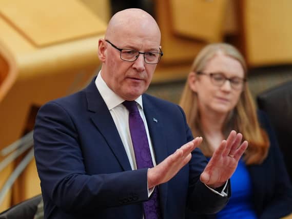 John Swinney standing while speaking in Holyrood