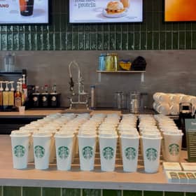 The first 100 customers to come through the doors following a ribbon cutting ceremony were given a free reusable cup.