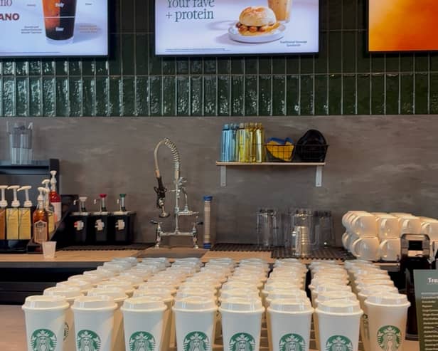 The first 100 customers to come through the doors following a ribbon cutting ceremony were given a free reusable cup.