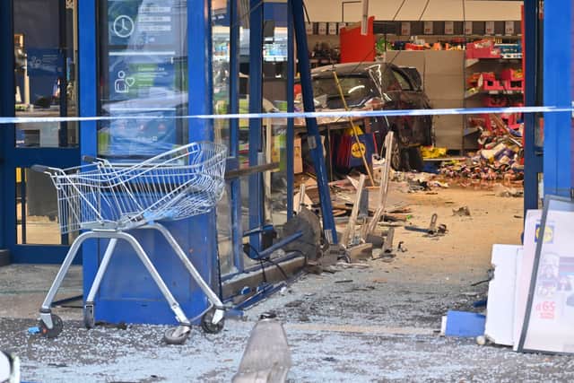 The car could still be seen at the back of the store, as well as the scene of devastation caused by the crash