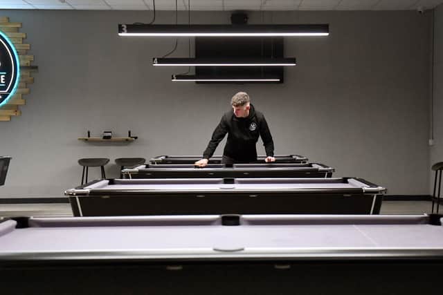 The bar has 12 pool tables, arranged with plenty of space between them