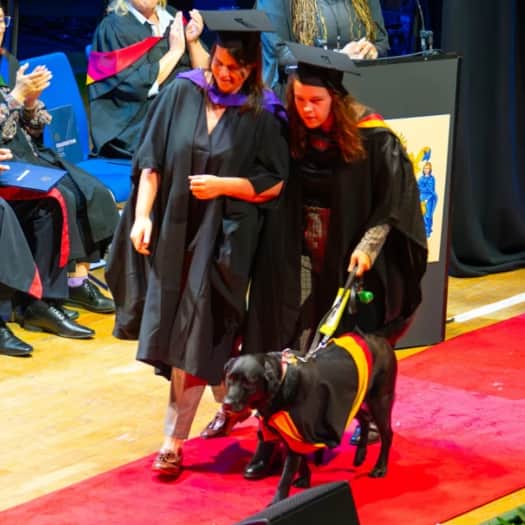 Caitlin Leigh graduates with her guide dog, Honey, at the University of Wolverhampton