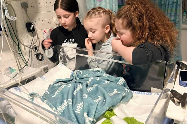 Laura children with Samson at hospital.