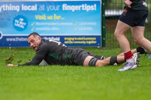 Bridgnorth's Dan Robinson slides in for a try against Lichfield.