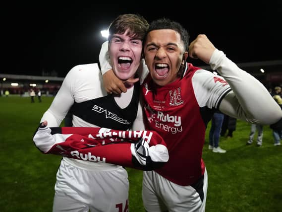 Fleetwood’s Conor Haughey, left, celebrates after scoring the winning penalty in the shootout win over Arsenal