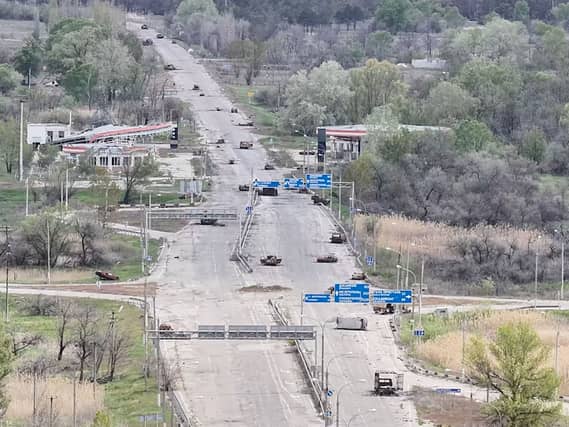 Destroyed cars are seen on a road from the Russian-occupied city of Oleshky in Ukraine