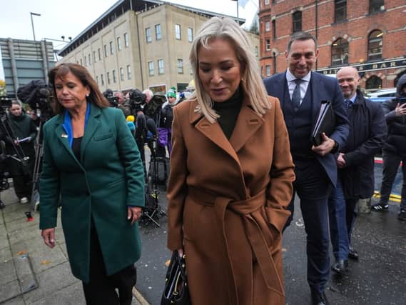 Sinn Fein president Mary Lou McDonald (left) and First Minister Michelle O’Neill arrive at Musgrave St police station in Belfast with solicitor Padraig O Muirigh