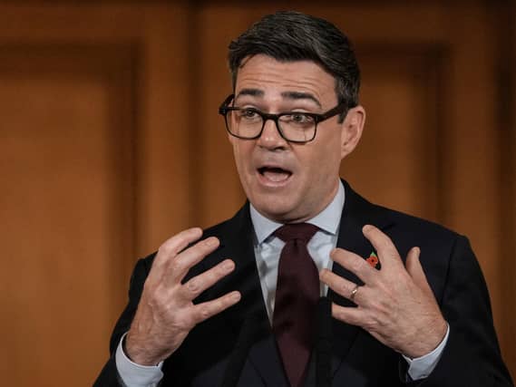 Andy Burnham gesturing with his hands as he makes a speech