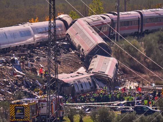 Wrecked train carriages lying on an embankment