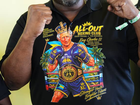 A member of staff wears a T-shirt featuring an illustration depicting the King as a boxer, ahead of his visit to the Bahamas Boxing Academy in Nassau