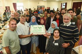 Front: The Akhtar Family, Back L-R Sajid Bashir, Alvina Ali from Secret Angels with Deputy Lieutenant Martin Levermore MBE DL, Warinder Juss MP for Wolverhampton West and Wolverhampton North East MP Sureena Brackenridge