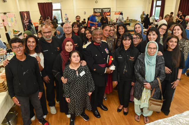 Front: Deputy Lieutenant Martin Levermore MBE DL, Alvina Ali, Nicki Kainth, Sajid Bashir from Secret Angels and volunteers, vendors and residents of Wolverhampton. Back Wolverhampton North East MP Sureena Brackenridge