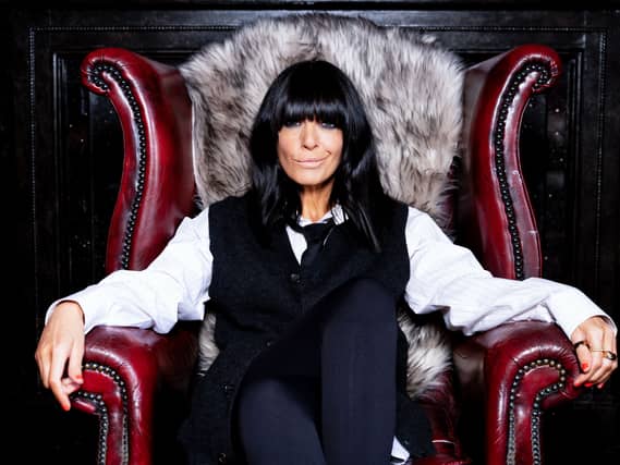 Claudia Winkleman sitting in a chair