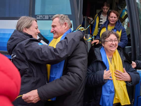 Evacuees from Oleshky cross the Belarus-Ukraine border in Chernyhiv