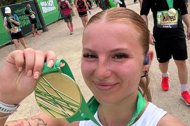 Chloe Shaw with her finisher's medal after raising £1,419 for Cure Leukaemia
