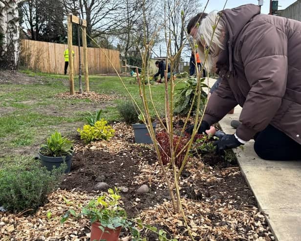 Customer planting at Milton place Community Garden
