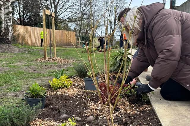 Customer planting at Milton place Community Garden