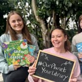 Library staff celebrating the libraries' environmental events with some recommended green reads