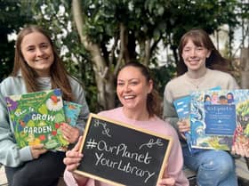 Library staff celebrating the libraries' environmental events with some recommended green reads