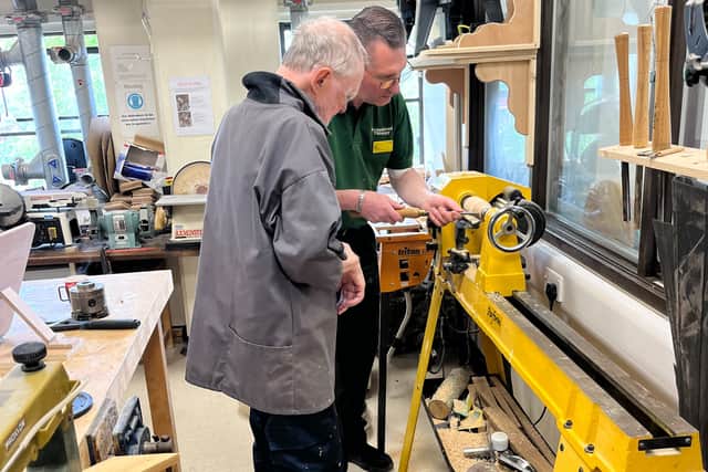 Ian shows Cyd wood turning skills