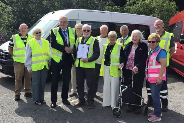 High Sheriff Maynard Burton presents Jonathan Haley with his award at a reception with volunteers, trustees, staff and service user Betty Nicholas