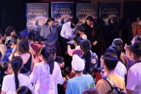 Flex Singh signs posters for young fans after the sold-out Slough premiere