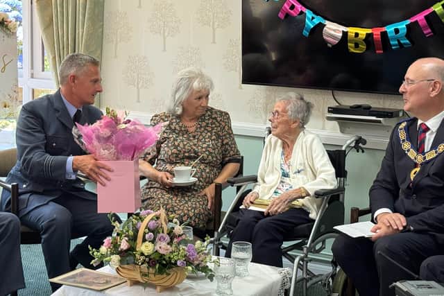 Ivy receiving flowers from Dave Kerrison, Chief of Staff RAF Cosford