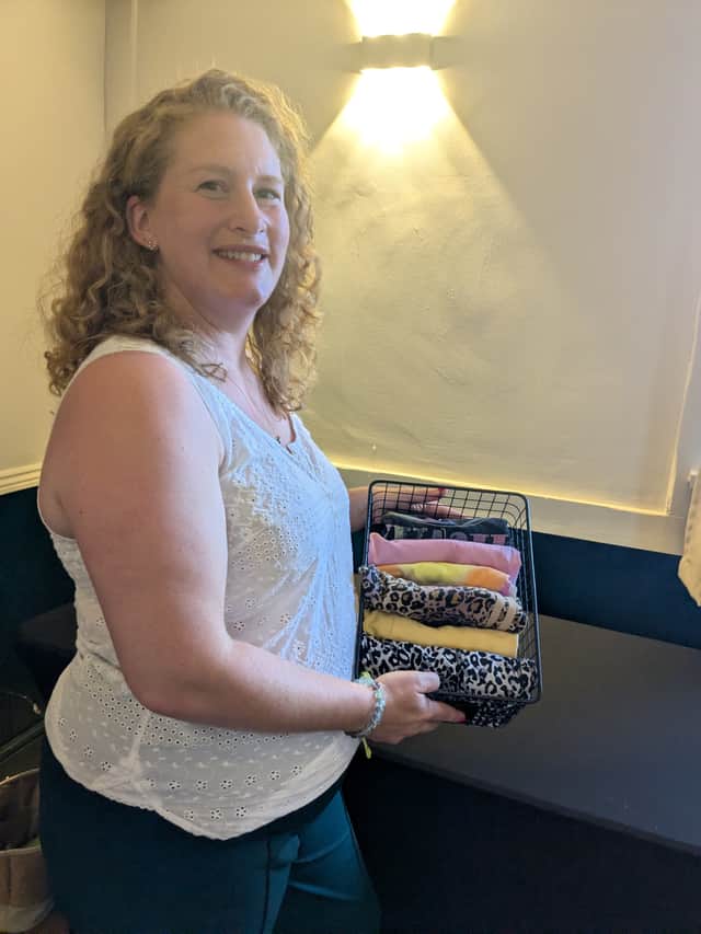 Claire the declutterer with a basket of expertly folded clothes