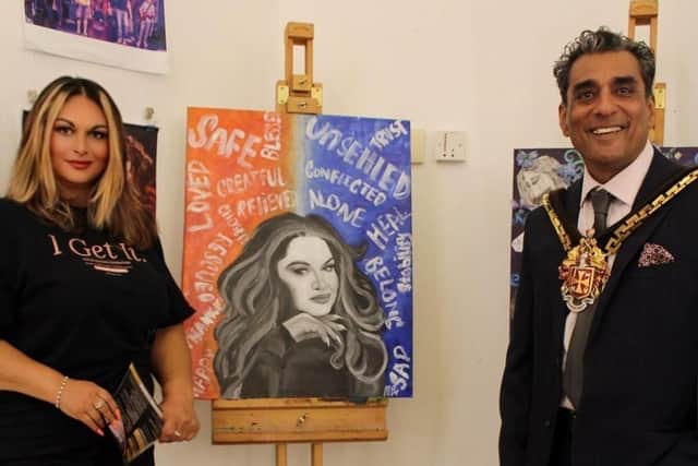 Founder Susan Vickers and Mayor of Wolverhampton Cllr Paul Singh, with artwork by artist Mia Bayley