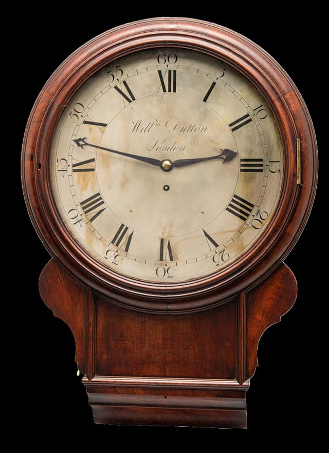 The lower case of a drop dial clock allows for a longer pendulum, which swings slower and keeps more accurate time than the short pendulums used in standard dial clocks