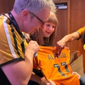 Alfred is presented a new Wolves shirt by Foundation ambassador Beverley Knight.