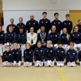 Young Gloves Karate members and instructors with the Mayor of Kidderminster, Councillor Shazu Miah, and Birchen Coppice Primary Academy Headteacher Mrs Sandra Pennington during a special celebration at the school.
