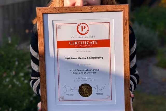 Penny Gibbs holding Prestige Awards certificate
