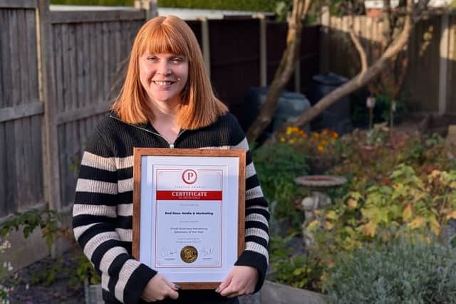 Penny Gibbs from Red Rose Media & Marketing holding the Prestige Award certificate