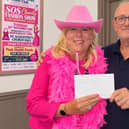 Licensee Mark Eustace of the Pear Tree Club presenting £100 to Rugeley and District Club President Debra Coburn
