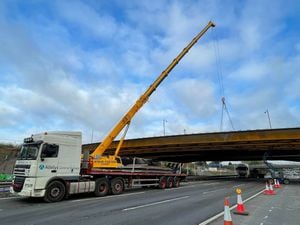 National Highways photo of crane lowering panels into a new bridge being built at Junction 10 of the M6 on October 10, 2021