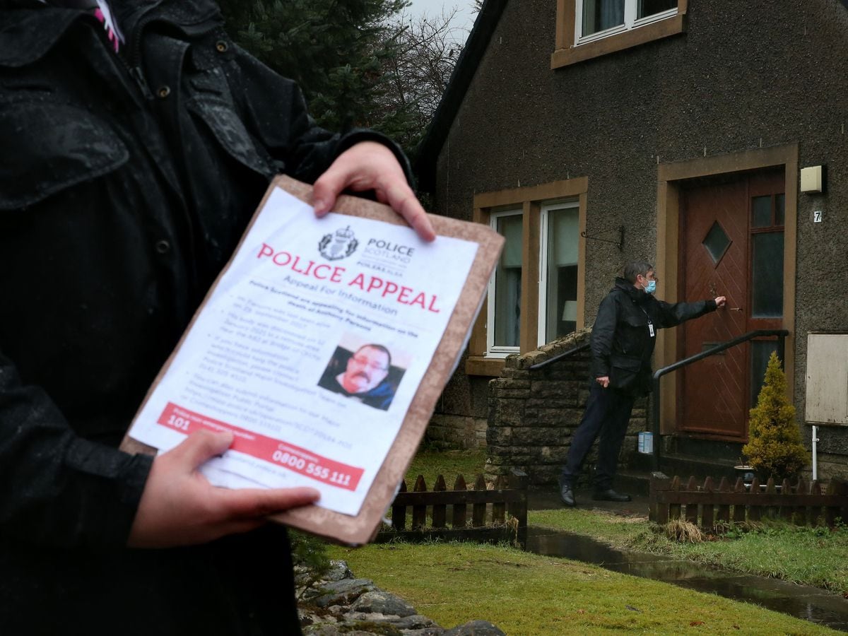 Police officers distribute posters and leaflets in Tyndrum, Stirlingshire, appealing for information on Tony Parsons