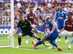               Aston Villa goalkeeper Emiliano Martinez saves a shot