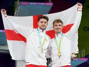 England's Anthony Harding and Jack Laugher enjoy their moment as Commonwealth champions. Photo: Tim Goode/PA Wire.            