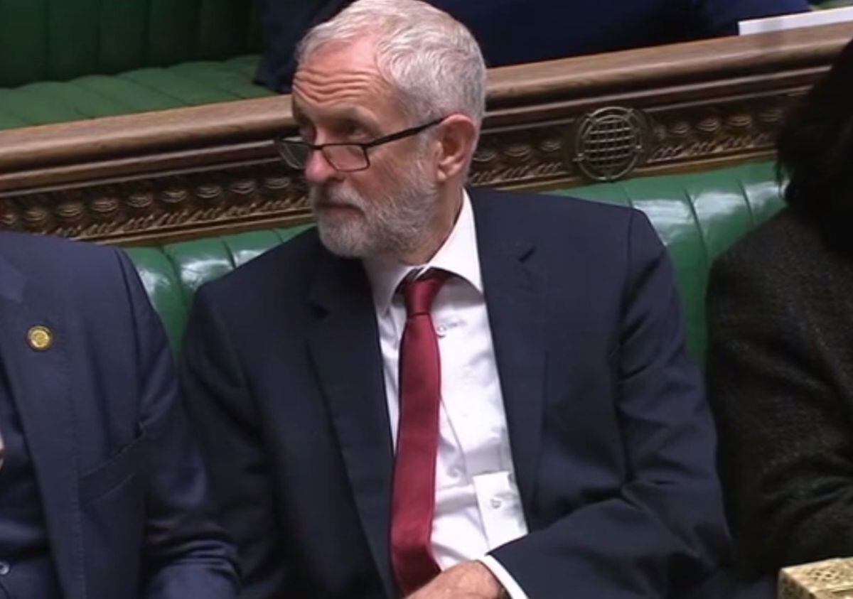 Jeremy Corbyn looked on as Mr Austin delivered his speech