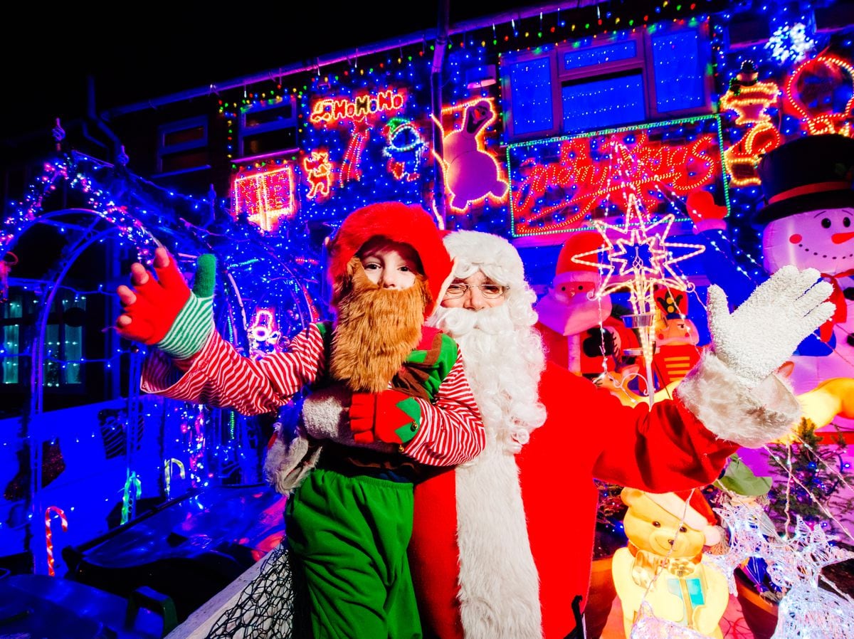 Gary Groves as Father Christmas and his son Thomas, six, as an elf, have for an 11th year decorated their home in Walsall