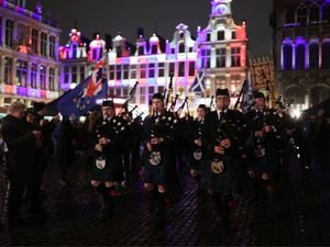 Members of the Celtic Passion Pipe Band playing in Grand Place in Brussels, Belgium, which is lit up in red, white and blue during a celebration and farewell on the eve of the UK leaving the European Union