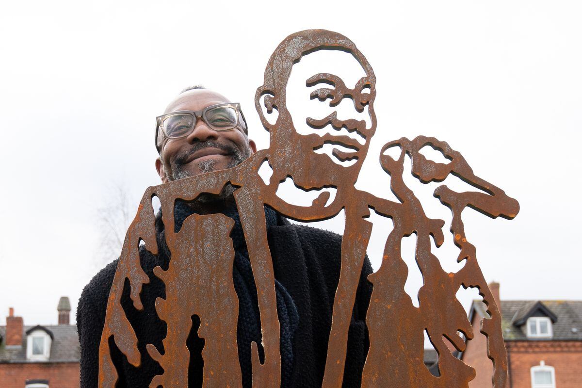 Sir Lenny Henry stands next to the unveiled statue at Olster Street park