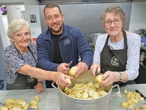 Good Shepherd chief executive Tom Hayden chips in helping in the kitchen with volunteers Elsie Hawthorne and Pam Smith.
