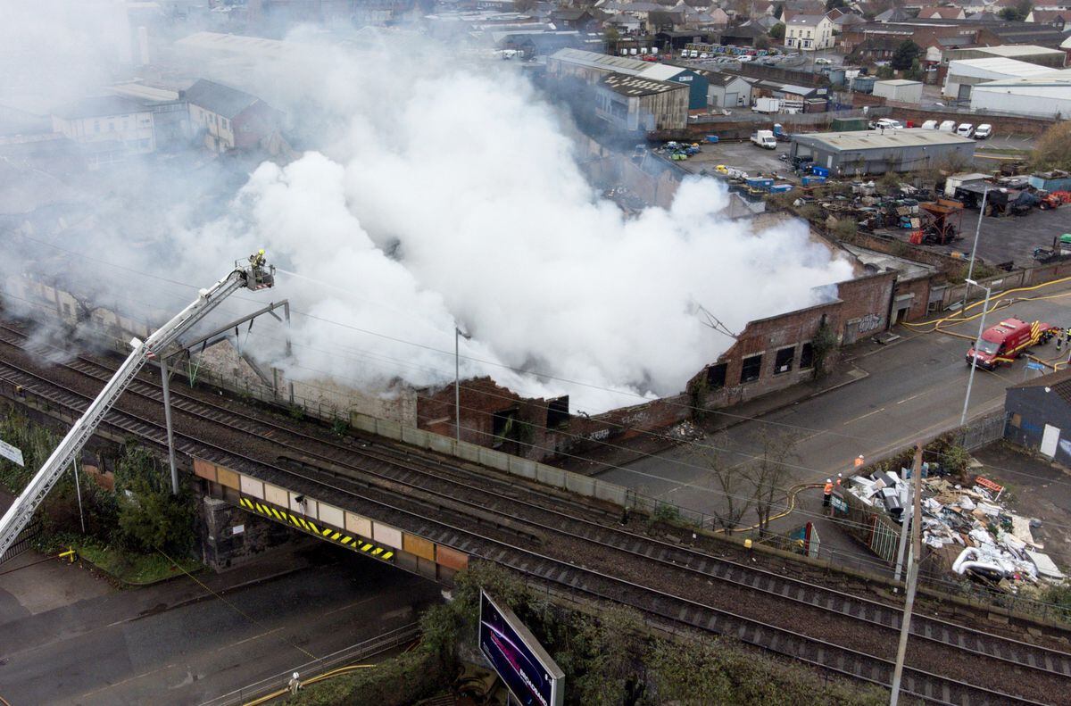 A bird's eye view of the site, still will heavy smoke and some areas still on fire. Photo: Jacob King/PA Wire            