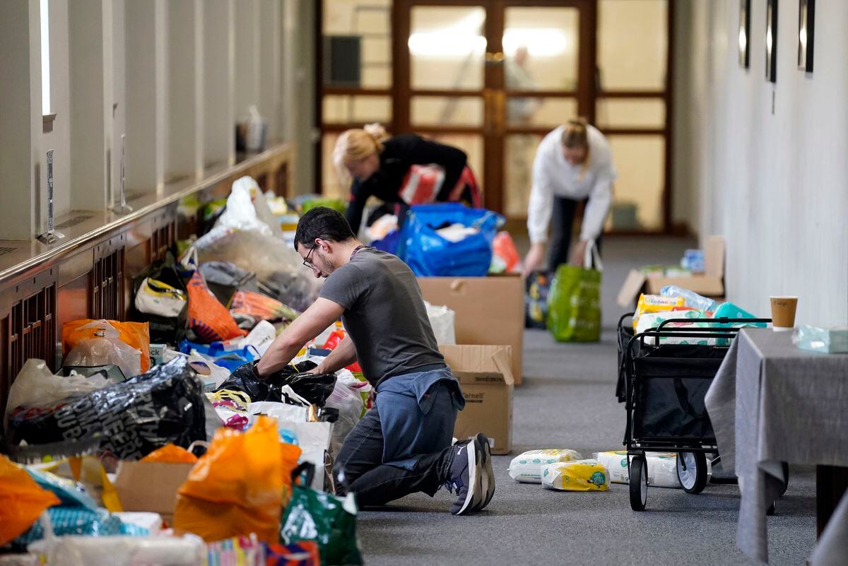 Volunteers help sort through fresh donations after more than 500 boxes of essential supplies were gathered by Parenting Network at Portsmouth Guildhall. Photo: Andrew Matthews/PA Wire