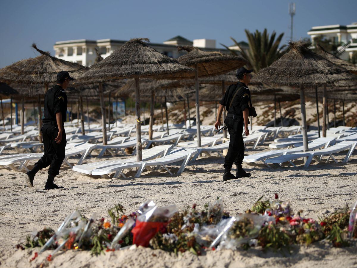 Police officers patrol the beach in Sousse, Tunisia, where 38 people lost their lives after a gunman stormed the beach