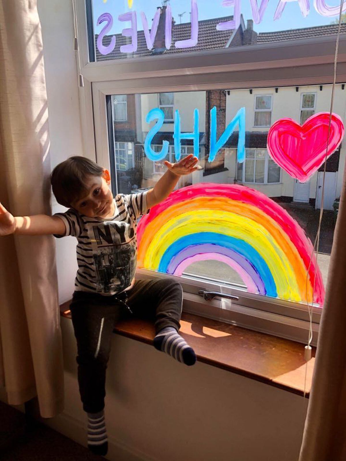 Noah Hill, aged two, at home with the rainbow in Fallings Park, Wolverhampton