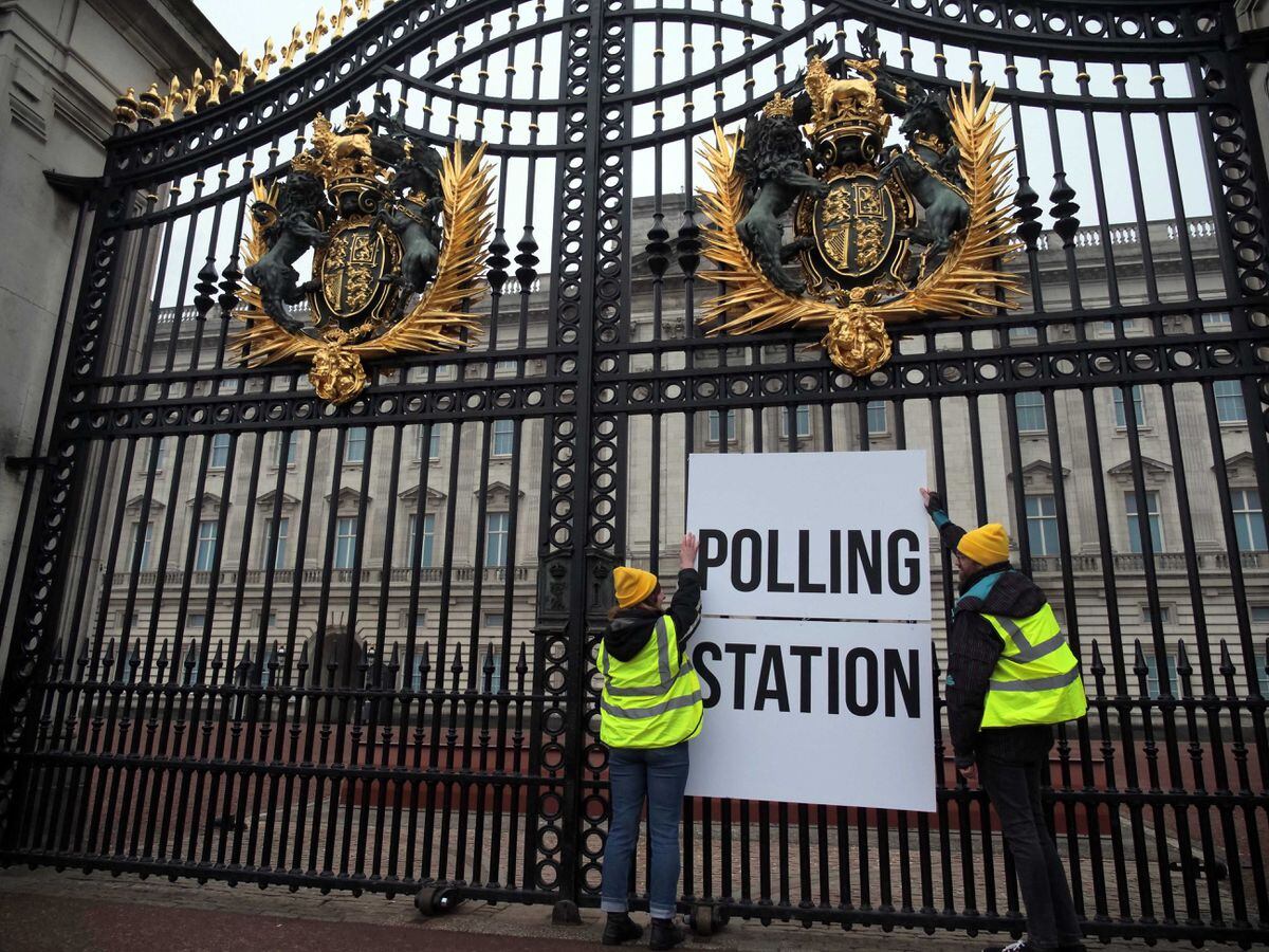 Activists from Republic put a polling station sign on the gates